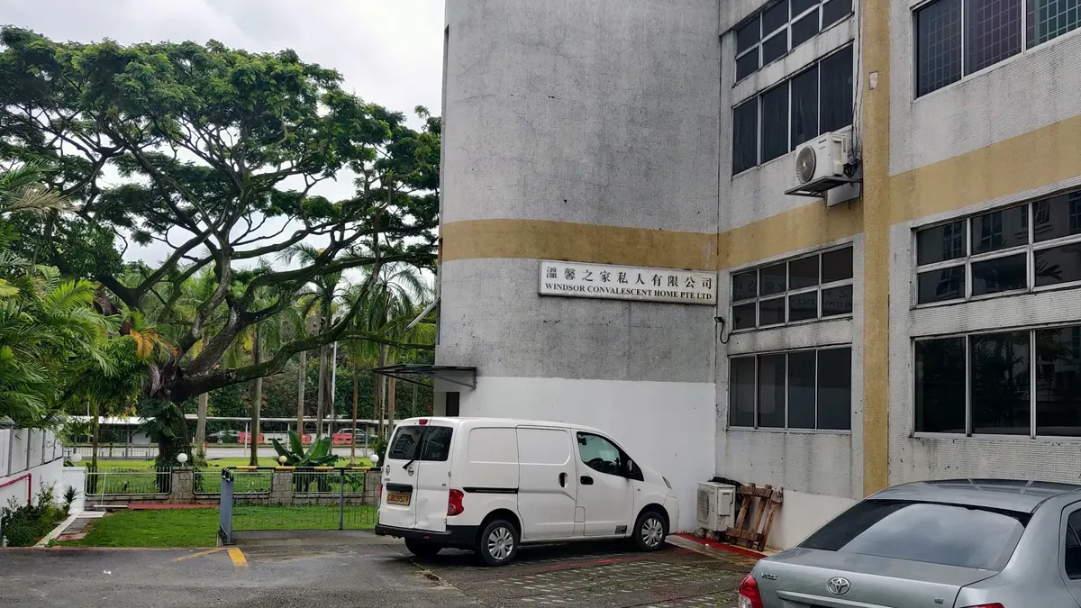 Exterior of Windsor Convalescent Home, a low-rise building at 369 Pasir Panjang Road, with its signboard and carpark visible.